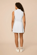 White | Woman wearing a white colored pleated skirt on a beige background