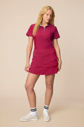 Aurora | Woman wearing the Aurora colored Lexi Polo and tulip skort on a beige background