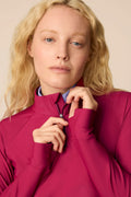 Aurora | Woman wearing a Aurora Taylor Long-Sleeve Half-Zip and skort on a beige background