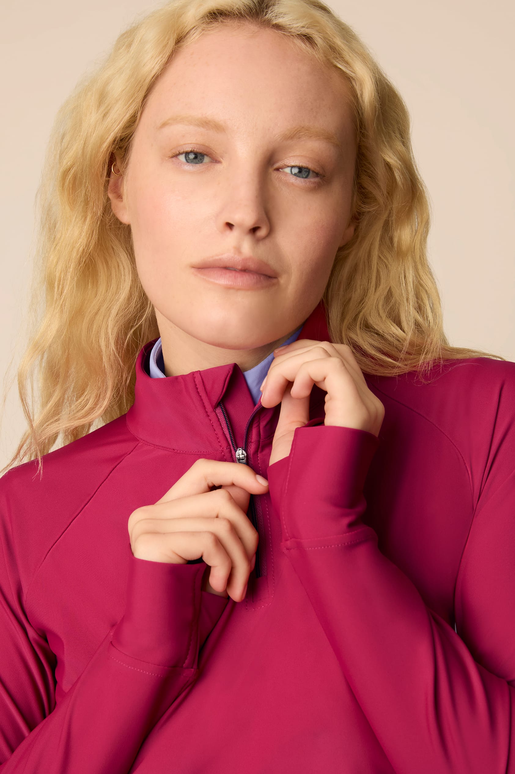 Aurora | Woman wearing a Aurora Taylor Long-Sleeve Half-Zip and skort on a beige background
