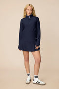 Midnight | Woman wearing a Midnight Taylor Long-Sleeve Half-Zip and skort on a beige background