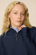 Midnight | Woman wearing a Midnight Taylor Long-Sleeve Half-Zip and skort on a beige background
