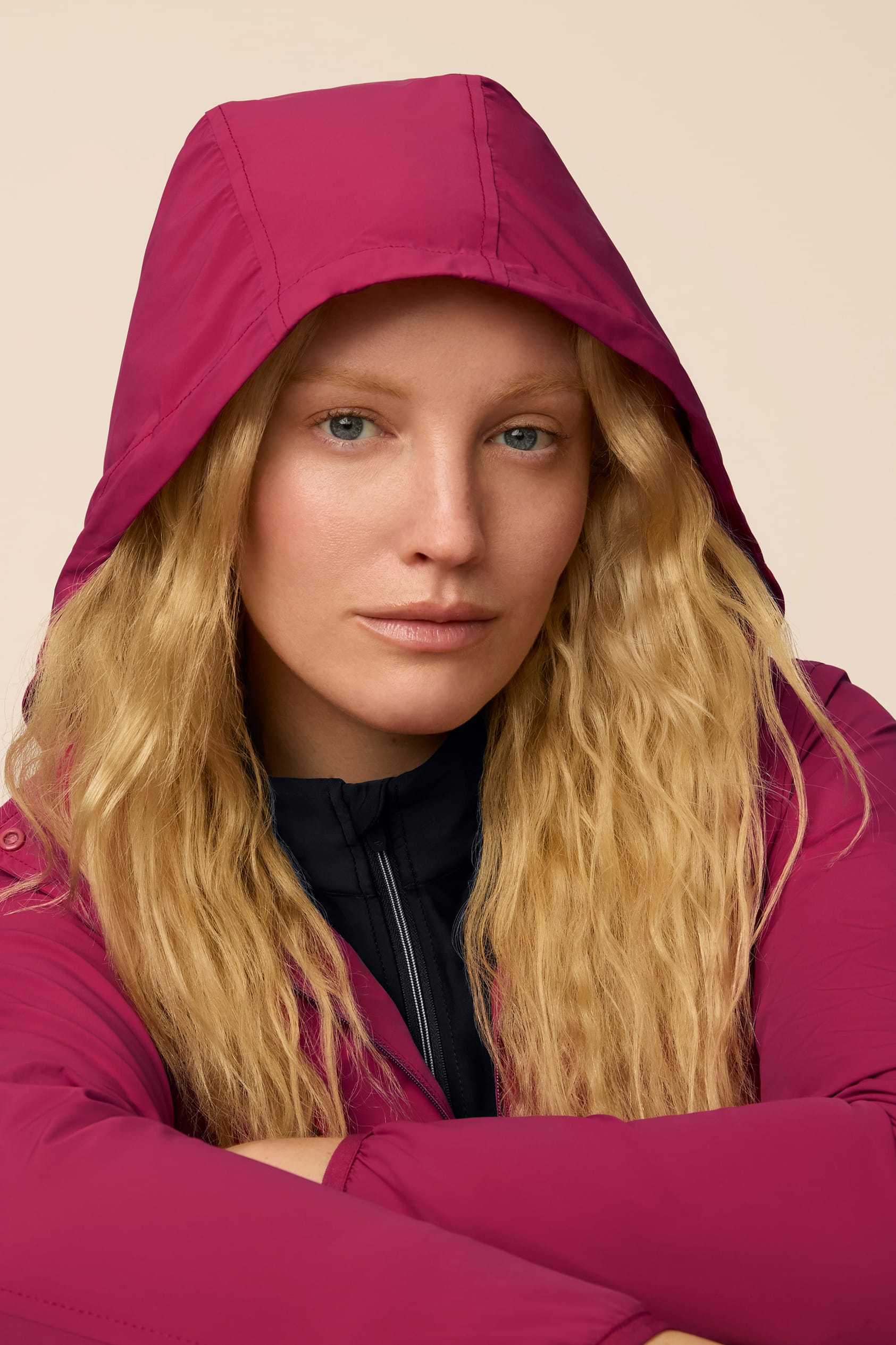 Aurora | Model wearing a hooded Aurora colored Gabrielle windbreaker with pleated skort.