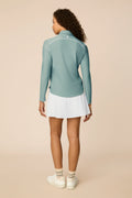 Meadow Haze | Woman wearing The Ella Long Sleeve Polo on a beige background
