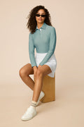 Meadow Haze | Woman wearing The Ella Long Sleeve Polo on a beige background