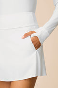 White | Model wearing a white Sophia a-line skort on a beige background
