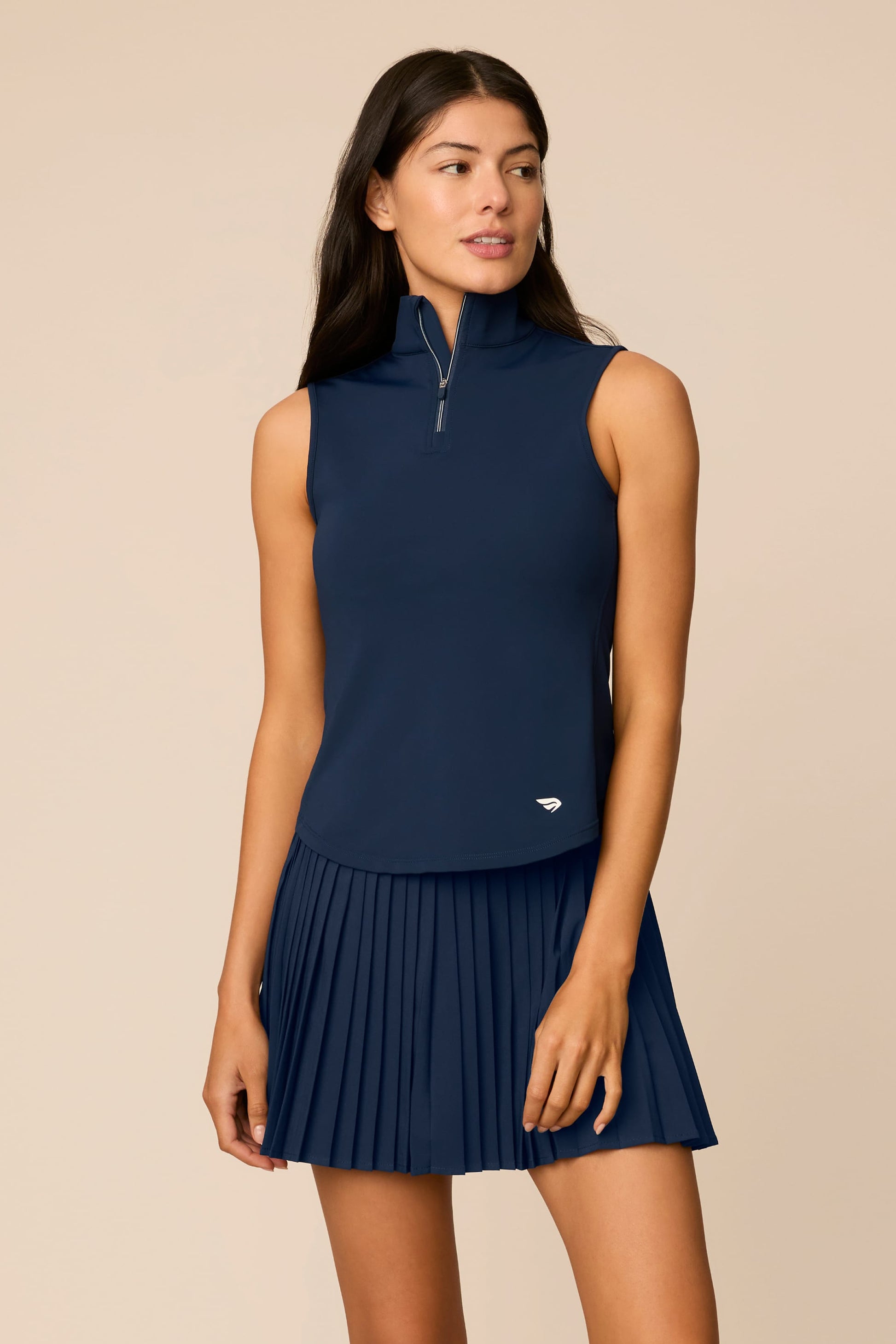 Midnight | Woman wearing The Michelle Pleated Skort 15" on a beige background