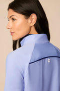 Woman wearing a Stardust half-zip long sleeve shirt with a beige background