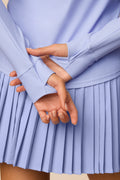 Stardust | Close-up of hands holding each other against a The Michelle Pleated Skort 15