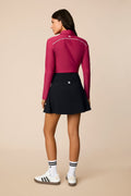 Aurora | Woman wearing The Ella Long Sleeve Polo on a beige background