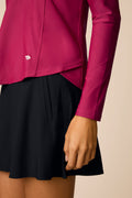Aurora | Sleve detail of a woman wearing The Ella Long Sleeve Polo on a beige background