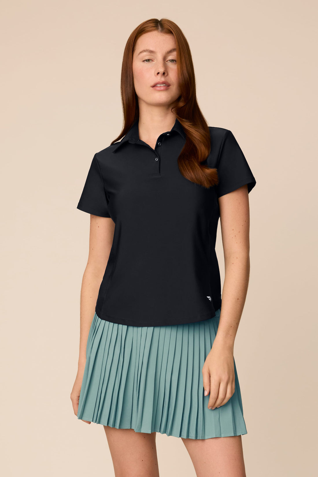Meadow Haze | Woman wearing a Meadow Haze colored Michelle pleated skort on a beige background
