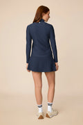 Midnight | Woman wearing The Ella Long Sleeve Polo on a beige background
