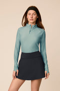 Meadow Haze | Woman wearing a Meadow Haze Taylor Long-Sleeve Half-Zip and skort on a beige background