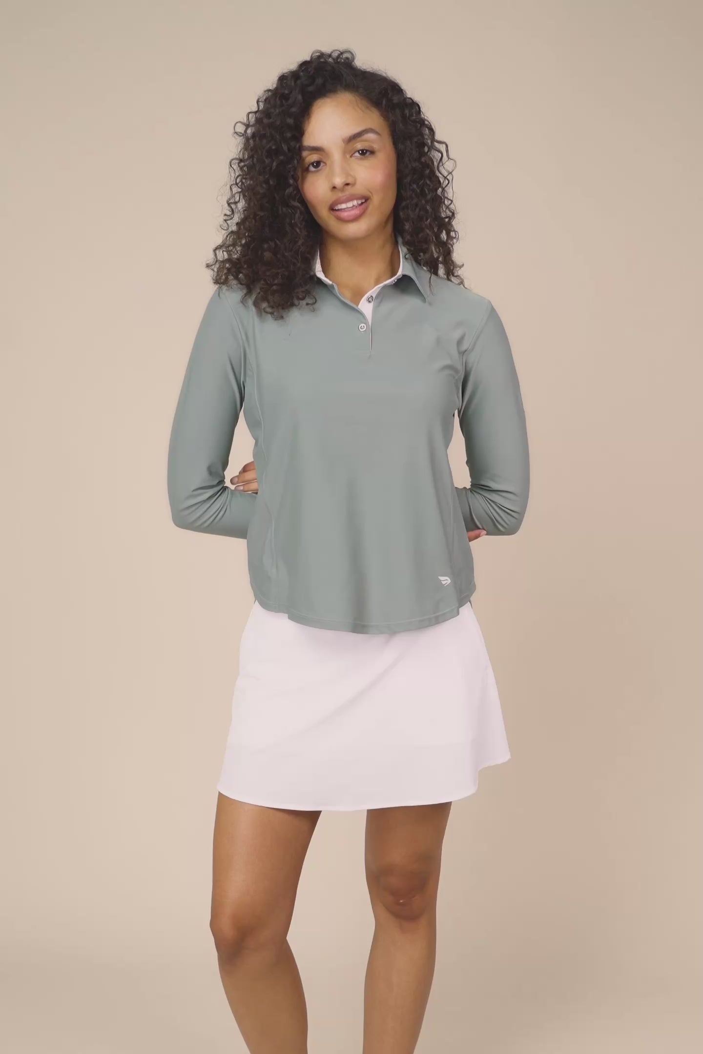 Meadow Haze | Woman wearing The Ella Long Sleeve Polo on a beige background