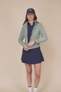 Meadow Haze | Model wearing a hooded Meadow Haze color windbreaker with white pleated skort.