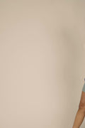 Meadow Haze | Woman wearing the Meadow Haze colored Lexi Polo and tulip skort on a beige background