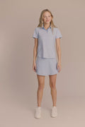 Skyline | Model wearing a skort and performance polo.